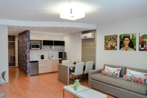 a living room with a couch and a table at Sofia Soberana Hotel Boutique in Bahía Blanca