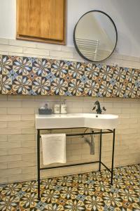 a bathroom with a sink and a mirror at Křišťanka - kouzelné apartmány in Prachatice