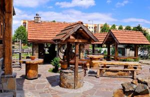 a pavilion with picnic tables and benches in a park at Dworek Sanocki in Sanok