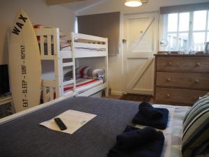 
a bedroom with a bed and a desk at Wax, Watergate in Newquay
