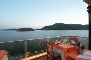 a dinner table on a boat in the water at Tymnos Hotel in Bozburun