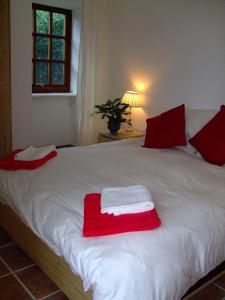 a bed with red and white towels on it at balcraggie in Glenelg