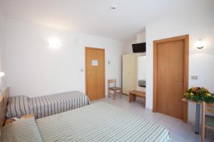 Postel nebo postele na pokoji v ubytování Hotel Nel Pineto