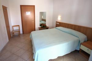 Postel nebo postele na pokoji v ubytování Hotel Nel Pineto