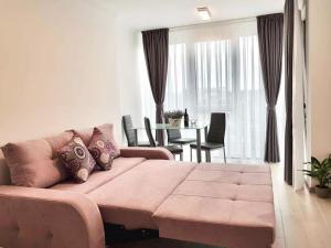 a living room with a pink couch and a table at Brand new apartment in Rebreanu Towers Residence in Timişoara