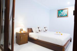 Postel nebo postele na pokoji v ubytování Suntari Homestay