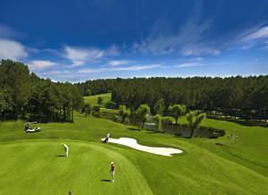a group of people playing golf on a golf course at Kemer Country Hotel İstanbul in Istanbul