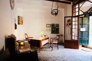 a living room with a table and chairs and a desk at Can Pera Accommodation - TI in Fornalutx