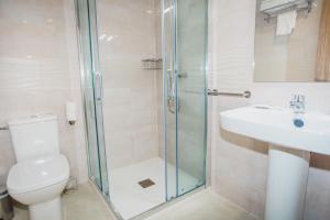 a bathroom with a shower and a toilet and a sink at Solesperit in Lloret de Mar