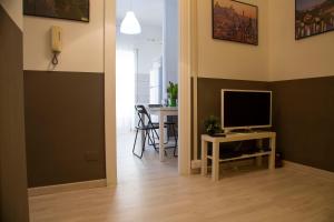 a hallway with a living room with a television and a table at San Silverio Luxury House in Rome