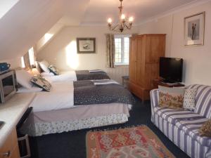 Un pat sau paturi într-o cameră la Maunditts House