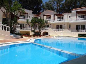 a large swimming pool in front of a building at Perla Beach in Agia Marina Nea Kydonias +37 photos