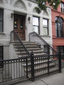 um conjunto de escadas em frente a uma casa em NYC Townhouse Apartment em Nova Iorque