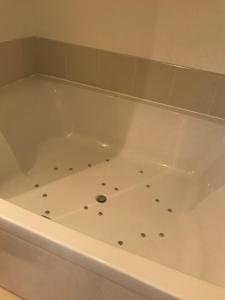 a white bath tub with polka dots in it at The Mill House Hotel in Buckie