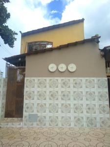 a building with two white plates on the side of it at Hostel Pigally in Goiânia