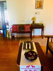 a living room with a couch and a table at Urban Retreat Homestay in Mangalore