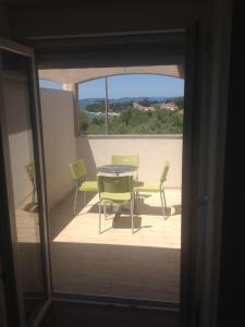 a view of a patio with a table and chairs at Apartments Dubravka in Pirovac
