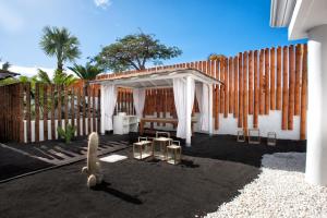 a backyard with a wooden fence and a white canopy at Guayarmina Princess - Adults Only in Adeje