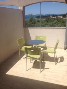 a patio with a table and chairs on a balcony at Apartments Dubravka in Pirovac
