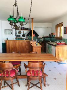 a kitchen with a large wooden table and chairs at Sea20.20 in Imperia