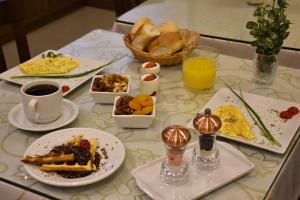 a table topped with plates of breakfast foods and drinks at Hotel Due Nobili in Gramado