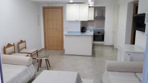 a kitchen and living room with a couch and a table at Apartment in LTI Mahdia Beach Hotel in Mahdia