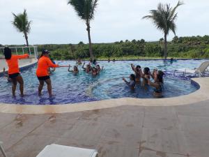 a group of people playing in a swimming pool at Salinas Park Resort in Salinópolis