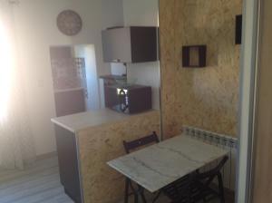 a kitchen with a table and a small table and a table and chairs at charmant studio coeur centre ville in Avignon