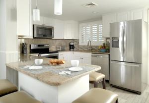 a kitchen with a granite counter top and a refrigerator at Tuckaway Shores Resort in Melbourne