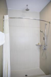 a shower with a shower curtain in a bathroom at BLVD Hotel & Spa - Walking Distance to Universal Studios Hollywood in Los Angeles