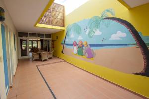 a hallway with a mural on the wall at Kas di Bientu at Windsock Beach in Kralendijk