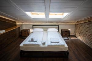 a large bed in a room with a skylight at Vysoka Khata 5 in Lviv