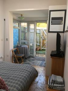 a bedroom with a bed and a table and a dining room at The Ceramic House in Brighton & Hove