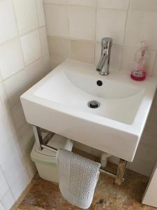 a white sink in a bathroom with a toilet at The Ceramic House in Brighton & Hove