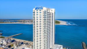 a tall white building with a sign on it next to the ocean at Boardwalk Resorts - Flagship in Atlantic City