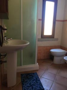 a bathroom with a sink and a toilet and a shower at West holiday in Nebida