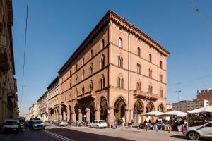 a large brick building on the side of a street at Indipendenza Boutique in Bologna
