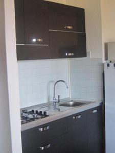 a kitchen with a sink and a stove at Villetta Vista Mare Calaverde IUN Q0265 in Santa Margherita di Pula