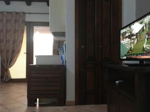a living room with a flat screen tv next to a door at West holiday in Nebida