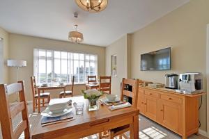 a kitchen and dining room with a table and a dining room at Haven Lodge Newquay in Newquay