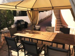 ein Tisch und Stühle unter einem Sonnenschirm auf einer Terrasse in der Unterkunft Villa Isla Lanzarote - Ciudad Quesada - Alicante in Ciudad Quesada