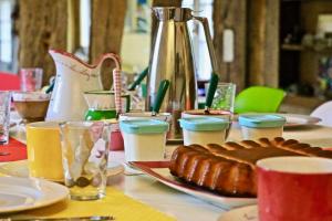 a table with a plate of food and drinks at La Longère Deauville in Bonneville-sur-Touques