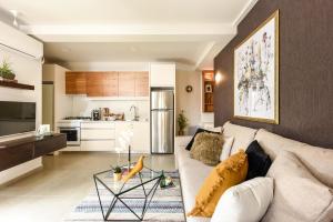 a living room with a couch and a kitchen at Sweet Inn - Chic Keren Hayesod in Jerusalem