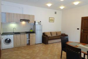 a kitchen with a washer and a couch in a room at Green Club in Tursko