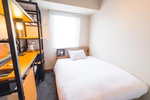 Postel nebo postele na pokoji v ubytování ICI HOTEL Asakusabashi