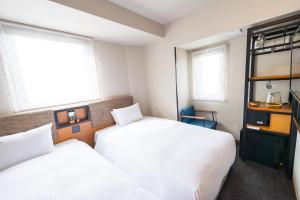 Postel nebo postele na pokoji v ubytování ICI HOTEL Asakusabashi