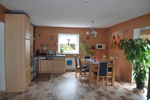 a kitchen with a table and a dining room at Casa Ramke in Eitorf +16 photos