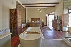 a large bathroom with a tub in a room at On Hotel Boutique in Sucre