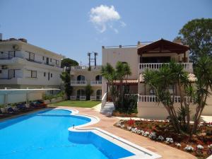 a swimming pool in front of a building at Perla Beach in Agia Marina Nea Kydonias