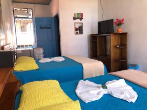 Postel nebo postele na pokoji v ubytování Hotel La Uvita